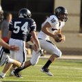 Bentonville senior quarterback Pearson Gean rolls out of the pocket against Bartlesville, Okla., dur...