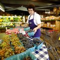 Agatha Penzo places quarts of grapes to be sold on a table Tuesday at Ranalli Farms Produce in Tonti...