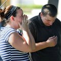 Church members react after a shooting that killed lay bishop Clay Sannar of the Church of Jesus Chri...