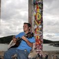 T.J. Burke from Springdale sings his own compositions Sunday for people who wandered through the rui...