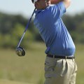 Rogers High senior Grant Washburn watches his tee shot on No. 8 during the Mounties’ match with Har-...