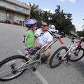 Dustin McDonald of Springdale prepares his daughter Abby, 4, for a bike ride around the Lake Fayette...