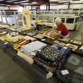 Mary Sagely of Fayetteville organizes the needle art entries Monday at the Washington County Fair. T...