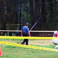 An officer walks near the site of a medical helicopter crash Tuesday.