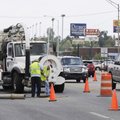 Crews from Springdale Water and Sewer Department inspect a sewer line Monday that had been blocked o...