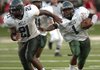 Mills quarterback Chris Hampton runs alongside teammate Michael Mayon during Tuesday’s game against Little Rock Parkview at War Memorial Stadium in Little Rock.