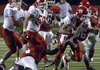 Cabot’s Zach Craig is tackled by a pair of Jacksonville defenders during Tuesday’s night’s game at War Memorial Stadium in Little Rock.