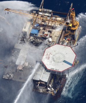 Boats are seen spraying water on an oil and gas platform that exploded in the Gulf of Mexico, of the coast of Louisiana., Thursday, Sept. 2, 2010. All 13 crew members were rescued. 