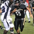 Bentonville defensive lineman Chase Gogel closes in on Conway’s Xavier Acklin on Sept. 4 in Tiger St...