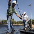 PAINT JOB - Micah Carson, left, and David Sandoval, both with LERenner Sports Surfaces of Denver, us...
