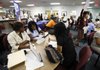 In this photo taken Wednesday, Sept. 1, 2010, India Windon, left, and Nytoyia Windon, second from left, interview job seekers for their company Helpng Hands Resource Group at Workforce One in Hollywood, Fla. 
