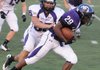 Fayetteville linebacker Ben Dubois tackles running back Deshunn Thomas on Aug. 23 in a scrimmage at Harmon Field in Fayetteville.
