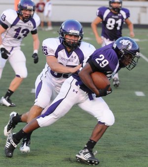 Fayetteville linebacker Ben Dubois tackles running back Deshunn Thomas on Aug. 23 in a scrimmage at Harmon Field in Fayetteville.
