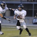  Bentonville Black’s Jacob Sisson, right, hands off to running back Clay Wallace while taking on Ben...