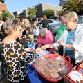 Sondra Smith, Fayetteville city clerk, left, takes an entry ticket from Joyce Richards, a longtime F...