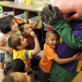BIG HUG - Antonio Cordero, 4, hugs Chuck E. Cheese at the Sunshine School on Thursday as other stude...