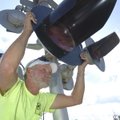 BRIGHT LIGHTS - Glen Rhodes with the Arkansas & Missouri Railroad aims a replacement light Thursday ...