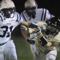 Rogers High running back Bronson Carpenter avoids a tackle by Johnny Lowe of Neosho, Mo., in the sec...