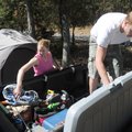 Jeff and Liz Harms of Hillsboro, Kan., unpack camping supplies Friday, at Prairie Creek park on Beav...