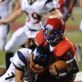 Quarterback Markeith Jacobs of Helena-West Helena Central is tackled by Rogers Heritage defensive ba...