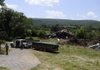 Work crews clear brush and debris from the old Judge Cummins ranch on July 25, 2008. The property is part of the Southpass development that has been in the works for more than six years. By Friday, Fayetteville expects to hold the deed to more than 200 acres planned for a park.
