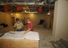 Jerry Smith, superintendent for the UAMS Northwest construction project, left, looks over plans Wednesday with electrician Jason Underwood. The space will allow the campus, the former Washington Regional Medical Center, to enroll pharmacy students.
