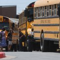 Students prepare to board buses Thursday at Mary Mae Jones Elementary School in Bentonville. The sch...