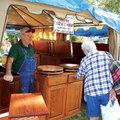 Kenneth Davis of Davis Cabinet Shop in Alpena visits with customers Saturday at the 59th annual Clot...