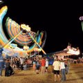 Patrons wait in line Friday to ride the Extreme, a ride featured in the midway provided by Reed Expo...