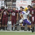 Little Rock Catholic’s Charley Gardner scores a touchdown on the opening kickoff of the game against...