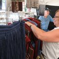 Ann Johnson of Farmington looks through some clothing Sunday at Claude’s Country Threads of Stover, ...