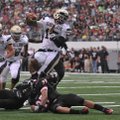 Shiloh Christian quaterback Kiehl Frazier jumps over defenders from Euless Trinity (Texas) for a tou...