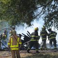 BARN FIRE - Battalion Chief Kyle Curry of the Fayetteville Fire Department, left, observes as firefi...