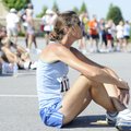Cheri Wood of Rogers rests Monday after participating in the Run for a Child race at Pinnacle Hills ...
