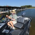 Ron Williams of Lowell launches his family’s boat Monday onto Beaver Lake at Hickory Creek Marina on...