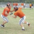 Gravette’s Tyler Greenhaw, right, locks up with a teammate during practice Tuesday in Gravette.
