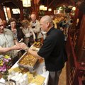Eric Lea, executive chef at Hog Haus, right, serves up samples Saturday of the restaurant’s shrimp a...