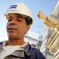Ahmed Benzizine stands in front the gargoyle portraying him at the Saint Jean cathedral in Lyon, cen...