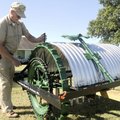 Tired Iron of the Ozarks President Glenn Smith explains Friday how a horse-drawn flail-type brush ho...