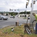 Greg Biswell pushes cable under College Avenue on Wednesday while working with a crew from the Fayet...