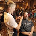 Nicole Shipley, a stylist from Studio 8 Salon in Fayetteville, left, prepares Shad Smith of Pea Ridg...