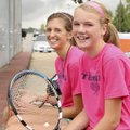 Rogers Heritage senior Emily Pappas, left, and sophomore Ellen Lundy take a break under stormy skies...