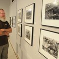LOOKING BACK - Fred “Spuds” Mackenzie of Bentonville looks over Danny Lyon’s photographs Thursday at...