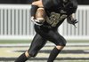 Bentonville Black’s Clay Wallace returns a kickoff Sept. 9 against Rogers Heritage in Bentonville.