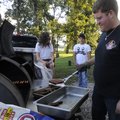 BACK-TO-SCHOOL BASH - Louis Hamilton, right, grills burgers and hot dogs Thursday while Meghan Ness,...