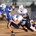 Central Junior High quarterback Kyle Pianalto is tackled by Woodland Junior High safety Tres Tucker ...