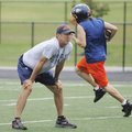 Rogers Heritage assistant coach Bo Black watches players run drills Thursday in Gates Stadium in Rog...