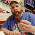 Craig Nelson prepares himself to eat the Insanity wings from Foghorn’s in Fayetteville.