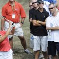 Fans surround Natalie Gulbis as she hits an off-course swing Friday on the 18th hole during the P&G ...