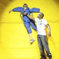 Sixth-grader Cristian Briggs answers a question Monday from Mike Peele while stuck to a Velcro wall ...